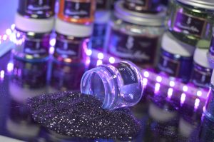 purple glass bottle on black textile