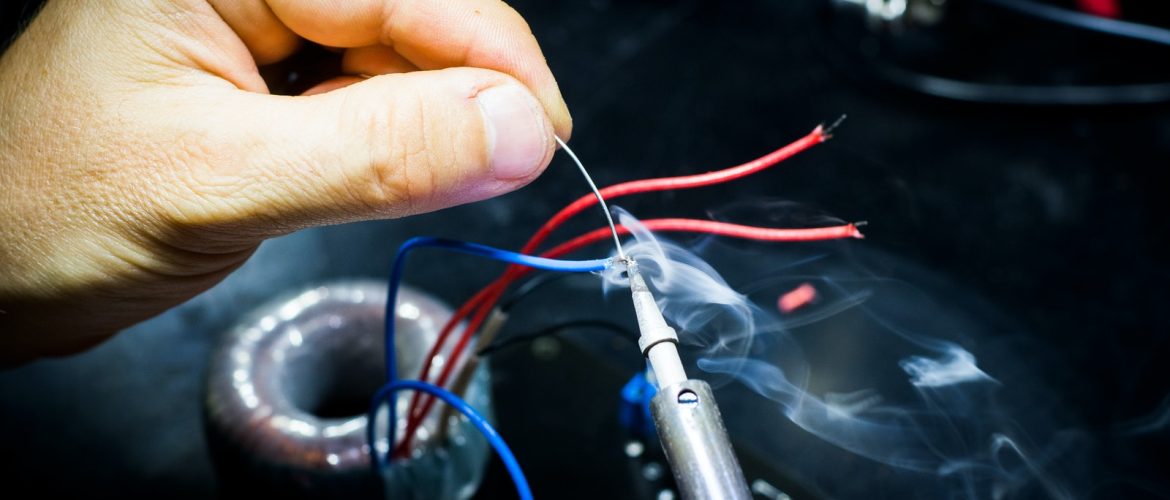 man soldering wires